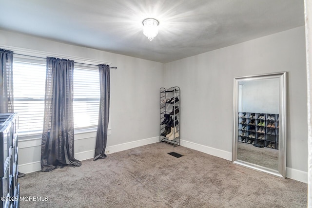 carpeted spare room with baseboards