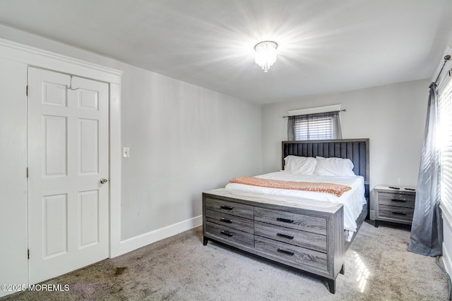 bedroom featuring carpet floors and baseboards