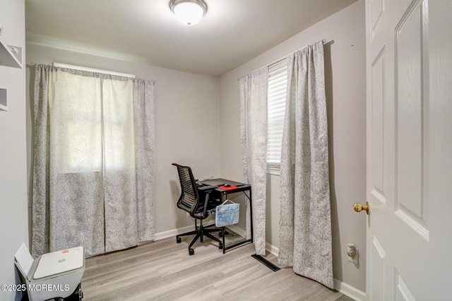 office space with wood finished floors and baseboards