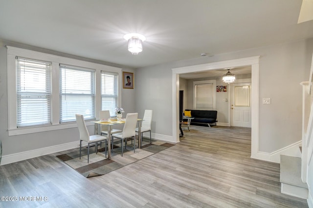 dining room featuring light wood-type flooring and baseboards