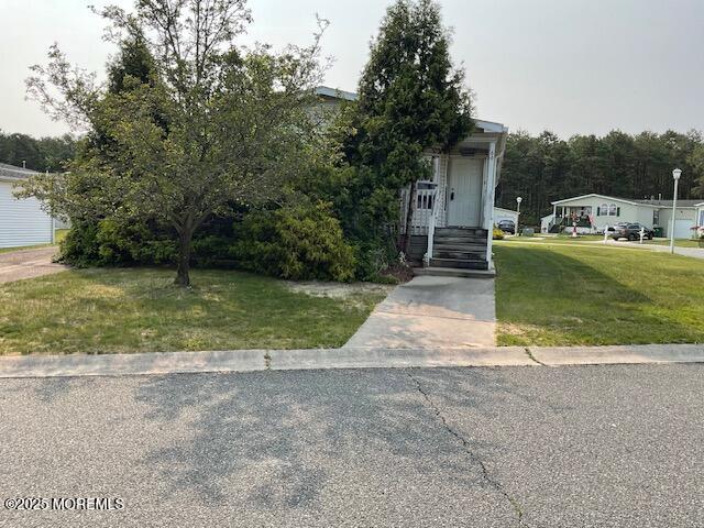 66 Pine Ridge Blvd, Whiting, NJ 08759 - view of property hidden behind natural elements featuring a front lawn
