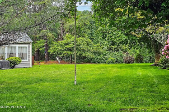 23 Lambeth Ln, Manchester, NJ 08759 - view of grassy yard featuring central AC unit