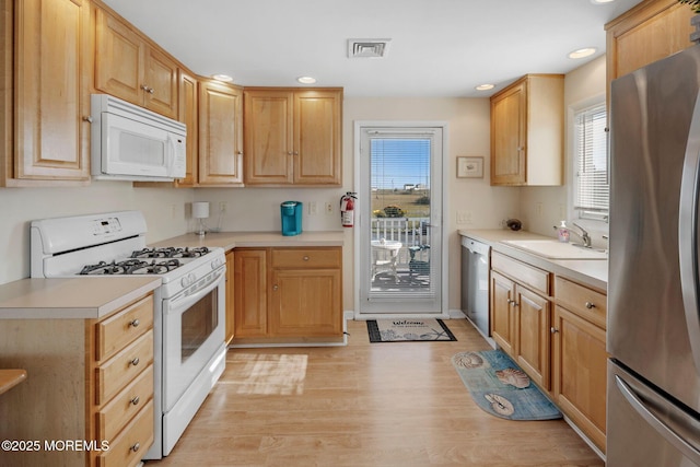 1255 W Mallard Dr, Stafford, NJ 08050 - kitchen featuring white appliances, a sink, light countertops, light wood finished floors, and recessed lighting