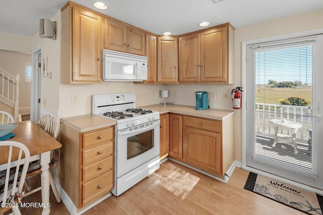 1255 W Mallard Dr, Stafford, NJ 08050 - kitchen featuring white appliances, light countertops, light wood finished floors, recessed lighting, and baseboards