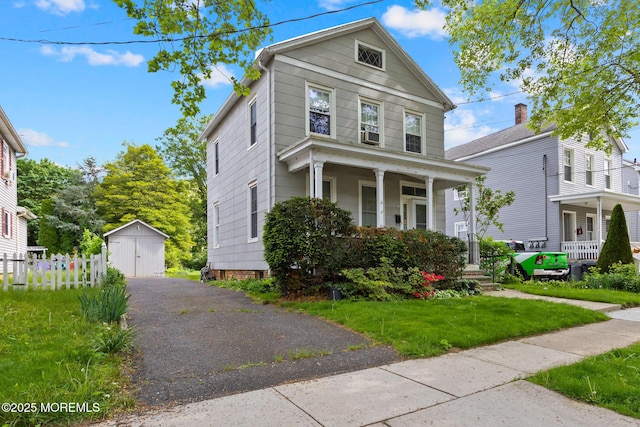 38 Bowne Ave, Freehold, NJ 07728 - american foursquare style home with a porch, an outbuilding, a front yard, and a garage