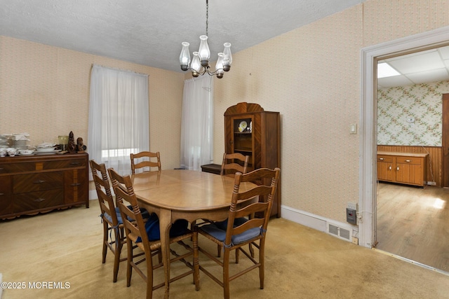 38 Bowne Ave, Freehold, NJ 07728 - dining space featuring wallpapered walls, a chandelier, carpet floors, and a textured ceiling