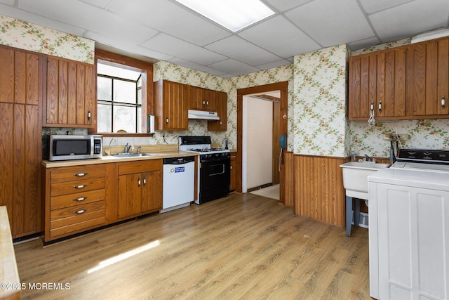 38 Bowne Ave, Freehold, NJ 07728 - kitchen with range with gas cooktop, stainless steel microwave, dishwasher, wallpapered walls, and under cabinet range hood