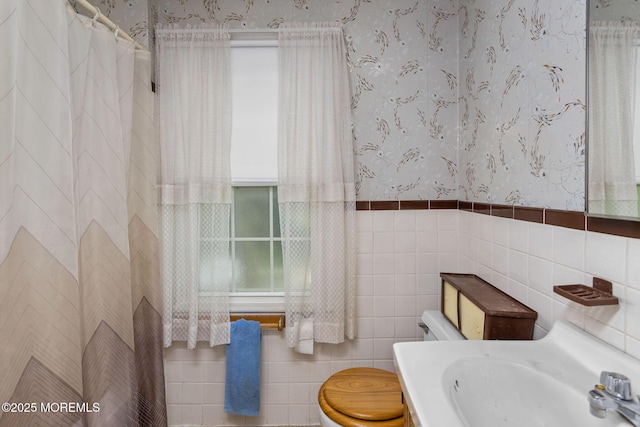 38 Bowne Ave, Freehold, NJ 07728 - bathroom featuring wallpapered walls, toilet, tile walls, a sink, and a shower with curtain