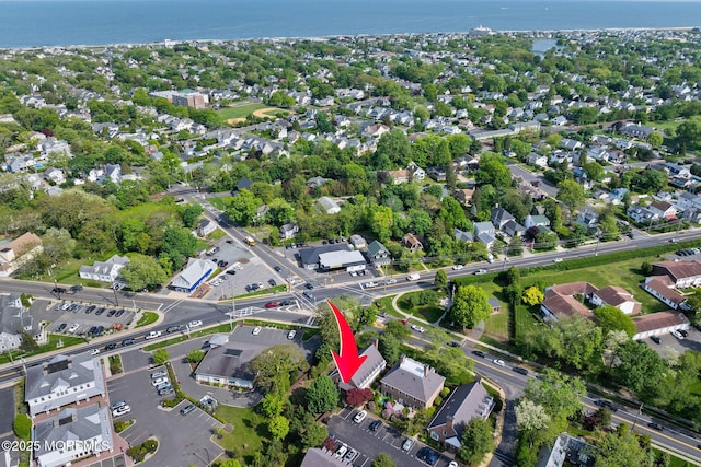 aerial overview of property's location featuring a large body of water and nearby suburban area