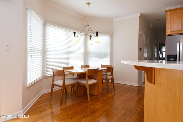 630 Springfield Ave, Pine Beach, NJ 08741 - dining area with a chandelier, crown molding, light wood-type flooring, and baseboards