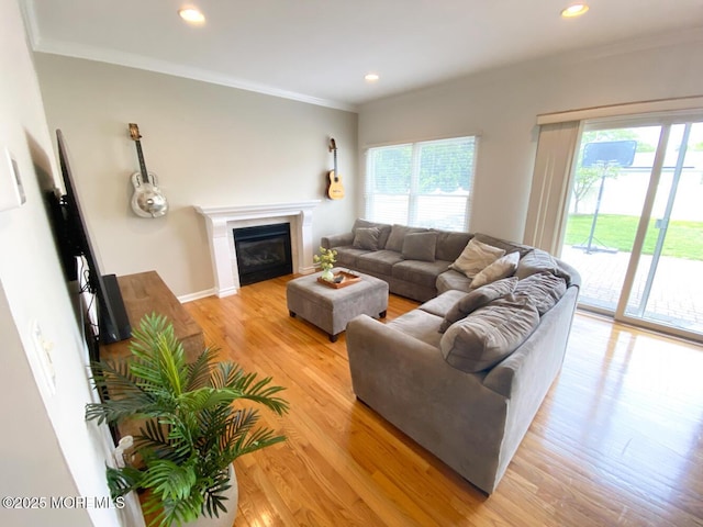630 Springfield Ave, Pine Beach, NJ 08741 - living area with healthy amount of natural light, light wood-style flooring, crown molding, a glass covered fireplace, and recessed lighting