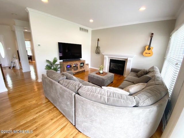 630 Springfield Ave, Pine Beach, NJ 08741 - living area with light wood-style floors, ornamental molding, a glass covered fireplace, recessed lighting, and ornate columns