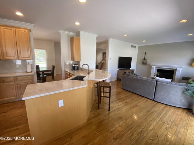 630 Springfield Ave, Pine Beach, NJ 08741 - kitchen with a sink, open floor plan, a kitchen breakfast bar, light countertops, and light wood-type flooring
