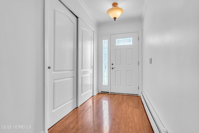 235 Prince Charles Ct, Toms River, NJ 08757 - entryway with light wood finished floors, crown molding, and a baseboard radiator