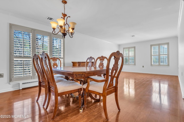 235 Prince Charles Ct, Toms River, NJ 08757 - dining room with a chandelier, baseboards, wood finished floors, and ornamental molding