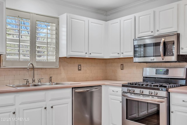 235 Prince Charles Ct, Toms River, NJ 08757 - kitchen with appliances with stainless steel finishes, a sink, white cabinets, light countertops, and ornamental molding