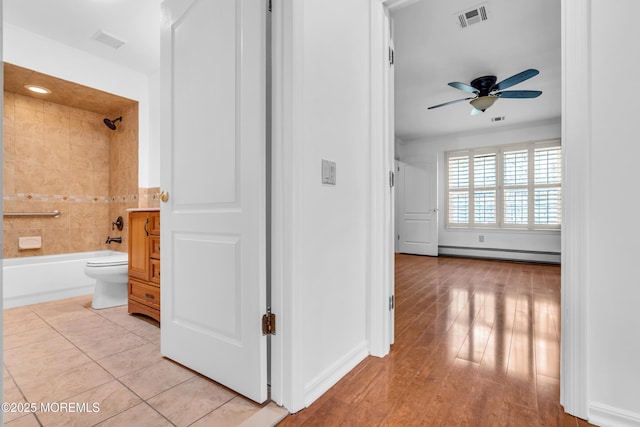 235 Prince Charles Ct, Toms River, NJ 08757 - hallway with baseboard heating, baseboards, and light wood-type flooring