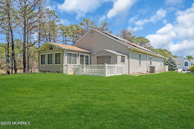 235 Prince Charles Ct, Toms River, NJ 08757 - rear view of house featuring a sunroom, a lawn, central air condition unit, and a shingled roof