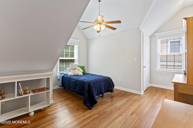bedroom with lofted ceiling, light wood-type flooring, baseboards, and ceiling fan