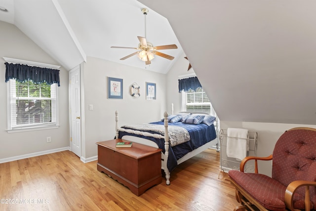 bedroom featuring lofted ceiling, light wood-style floors, a ceiling fan, and baseboards