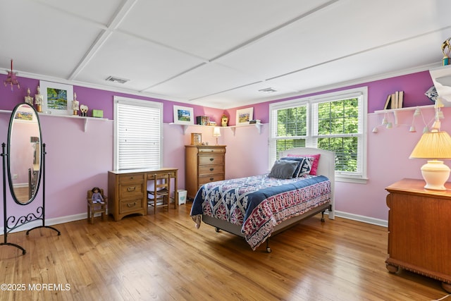 bedroom with baseboards, wood-type flooring, and crown molding