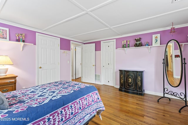 bedroom with wood finished floors and baseboards
