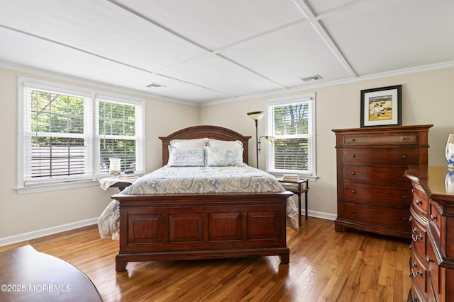 bedroom with baseboards, light wood-style floors, and ornamental molding