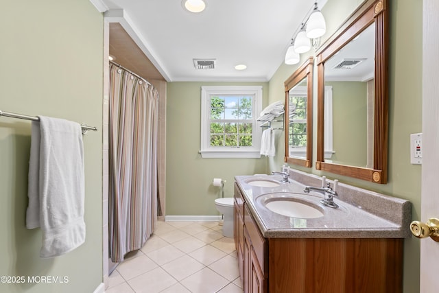 full bath with baseboards, double vanity, tile patterned floors, toilet, and ornamental molding
