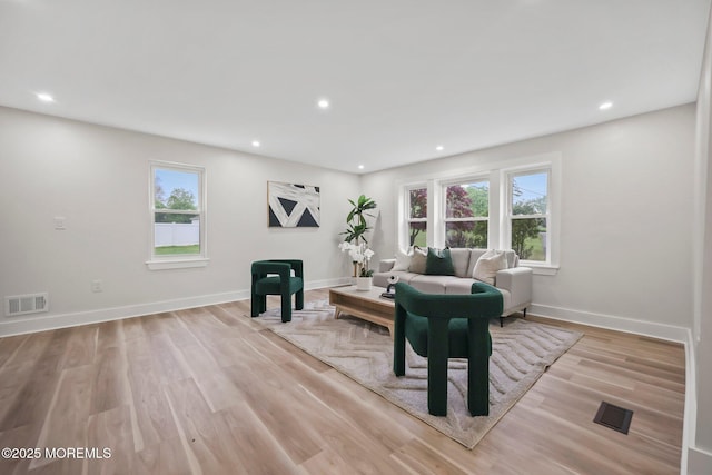 living room featuring recessed lighting, light wood-style floors, and baseboards