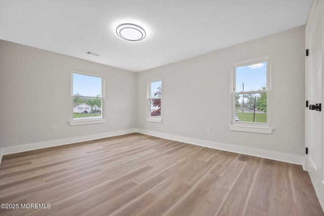 unfurnished room featuring light wood-type flooring and baseboards