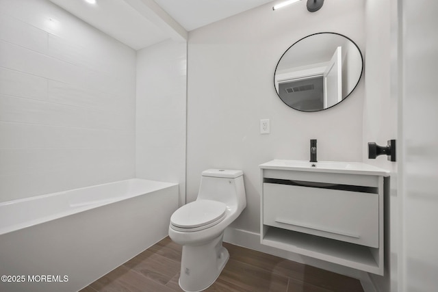 bathroom featuring wood finished floors, vanity, and toilet