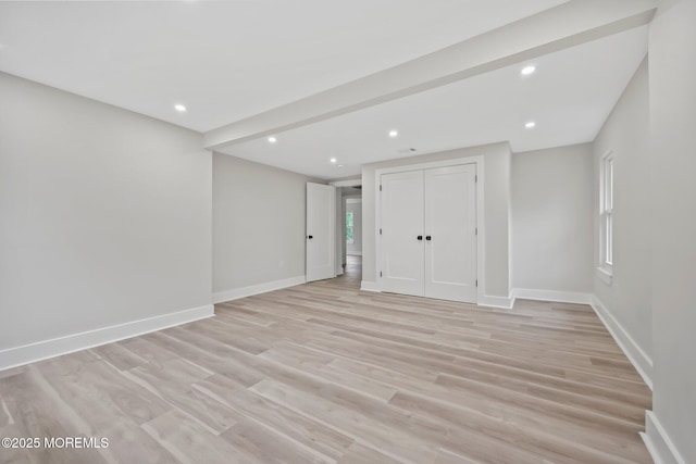 basement with baseboards, light wood-style flooring, and recessed lighting