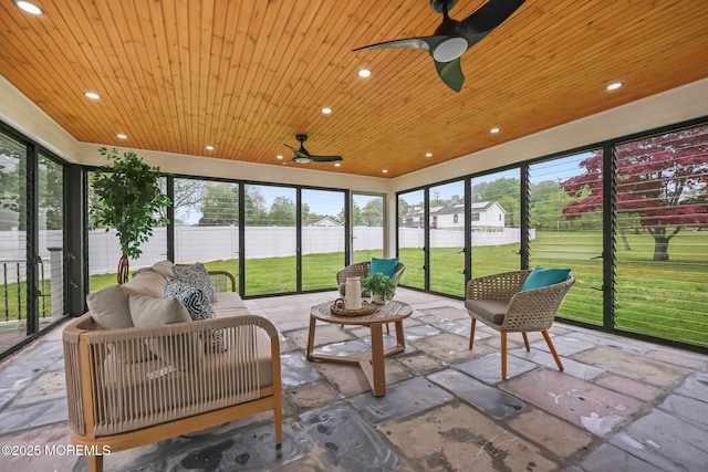 sunroom featuring ceiling fan, plenty of natural light, and an outdoor living space