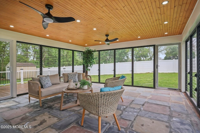 sunroom with a ceiling fan and outdoor lounge area