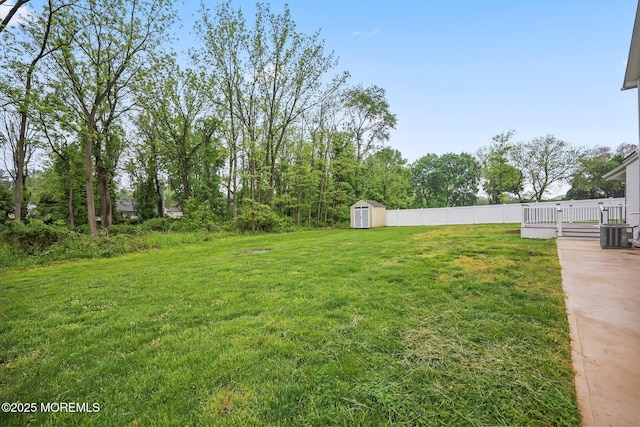 view of yard with a storage unit, an outdoor structure, and central AC unit