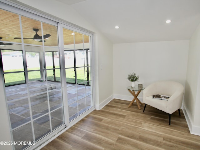 sitting room featuring baseboards, wood finished floors, lofted ceiling, and recessed lighting