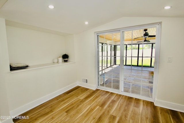 spare room with baseboards, wood finished floors, lofted ceiling, and recessed lighting