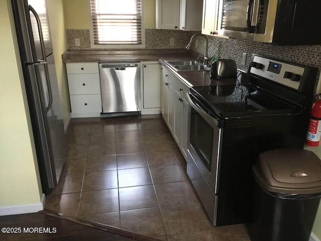 324 Webster Ave, Seaside Heights, NJ 08751 - kitchen with appliances with stainless steel finishes, a sink, white cabinets, and decorative backsplash