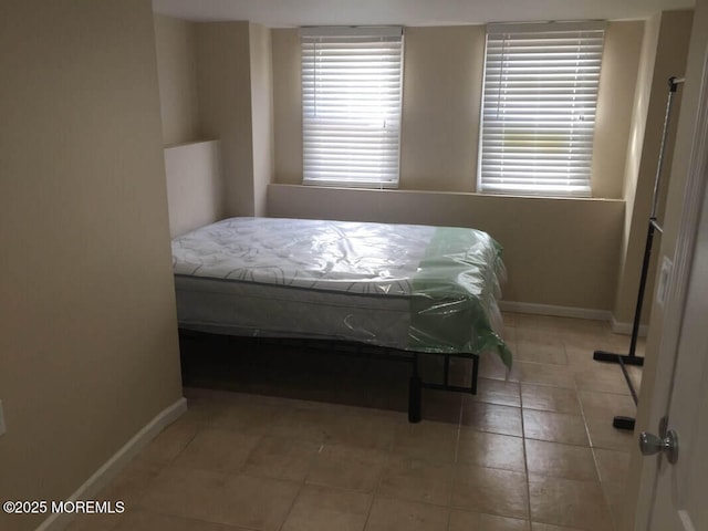 324 Webster Ave, Seaside Heights, NJ 08751 - bedroom featuring baseboards, light tile patterned floors, and multiple windows