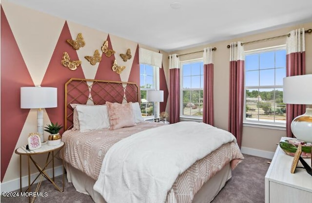 bedroom with baseboards and carpet