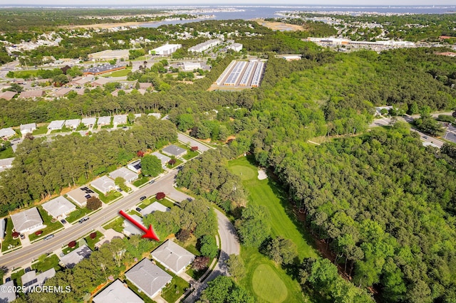 aerial view of property and surrounding area with nearby suburban area and a local golf course