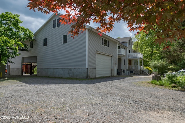 144-146 E Greystone Rd, Old Bridge, NJ 08857 - view of side of home featuring driveway, a garage, and a balcony