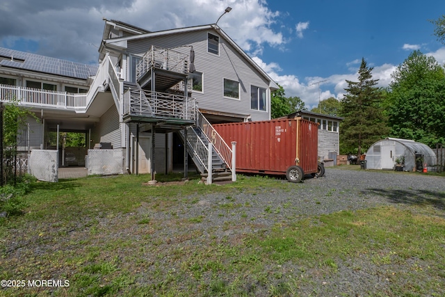 144-146 E Greystone Rd, Old Bridge, NJ 08857 - rear view of property featuring an exterior structure, an outdoor structure, stairs, and a yard