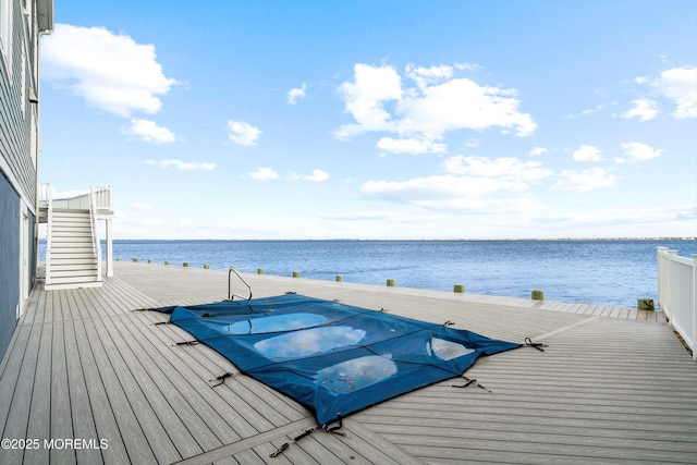 view of swimming pool with a water view