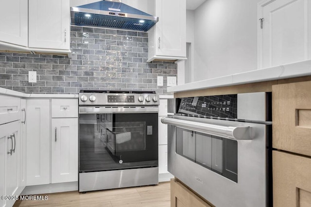 7 Leifried Ln, Tuckerton, NJ 08087 - kitchen with stainless steel appliances, extractor fan, light countertops, and white cabinets