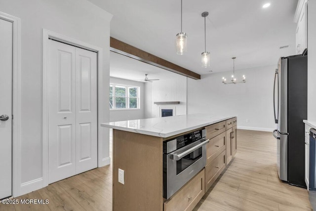 7 Leifried Ln, Tuckerton, NJ 08087 - kitchen with stainless steel appliances, light wood-style flooring, ceiling fan, baseboards, and a kitchen island