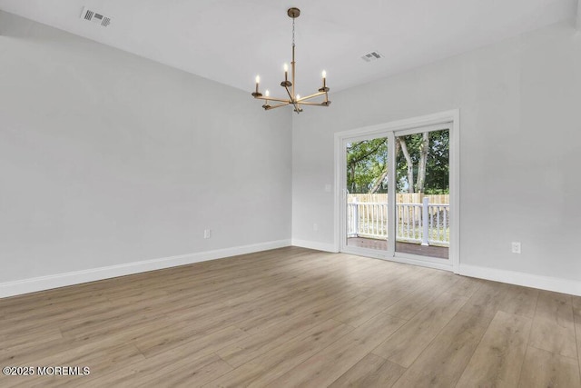 7 Leifried Ln, Tuckerton, NJ 08087 - empty room featuring a chandelier, wood finished floors, and baseboards