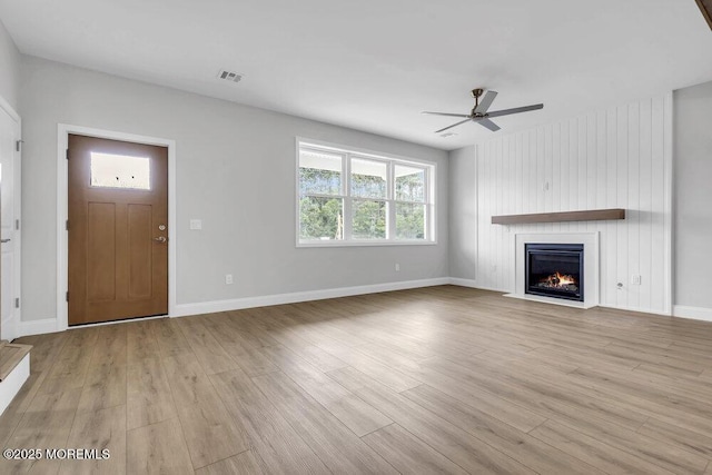 7 Leifried Ln, Tuckerton, NJ 08087 - unfurnished living room with a ceiling fan, light wood finished floors, a large fireplace, and baseboards