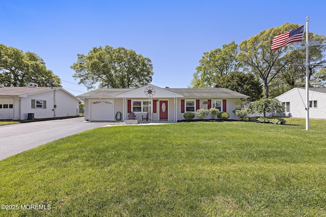 single story home featuring an attached garage, concrete driveway, a front lawn, and cooling unit