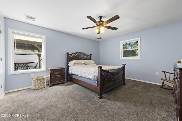 carpeted bedroom featuring baseboards and ceiling fan